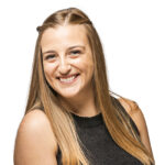Smiling woman with long blonde hair, working at an event planning company, wearing a black sleeveless top against a white background.