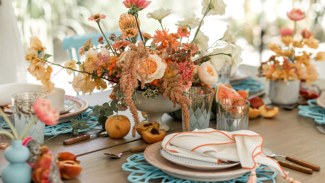 Viceroy Los Cabos Destination Wedding Reception table with colorful pink and orange florals. Designed by JWennes Events.