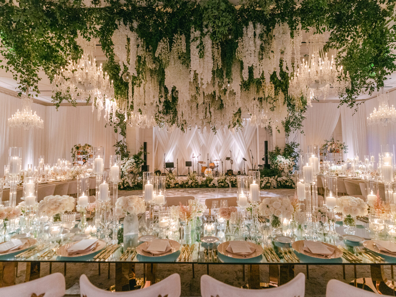 Dramatic wedding reception under a canopy of beautiful white florals. Designed by JWennes Events.