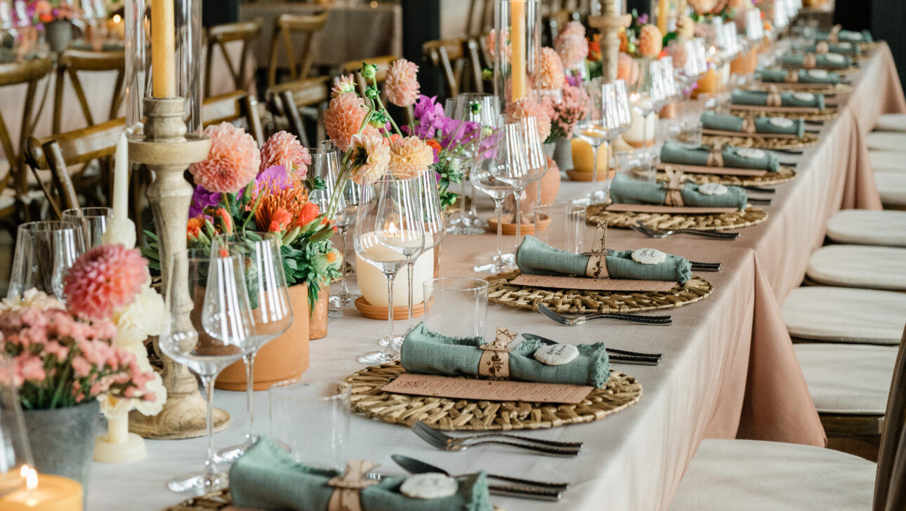 Stunning table setting with Aspen wildflowers, chargers with natural fibers and soft candleight.
