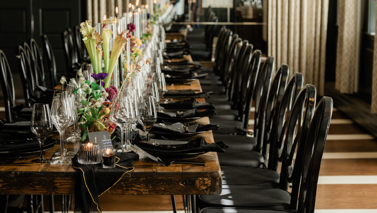 Private dinner setting with dark tones and black.