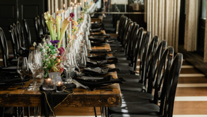 Private dinner setting with dark tones and black.